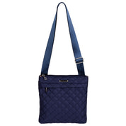 Navy quilted shoulder bag with a strap on a white background