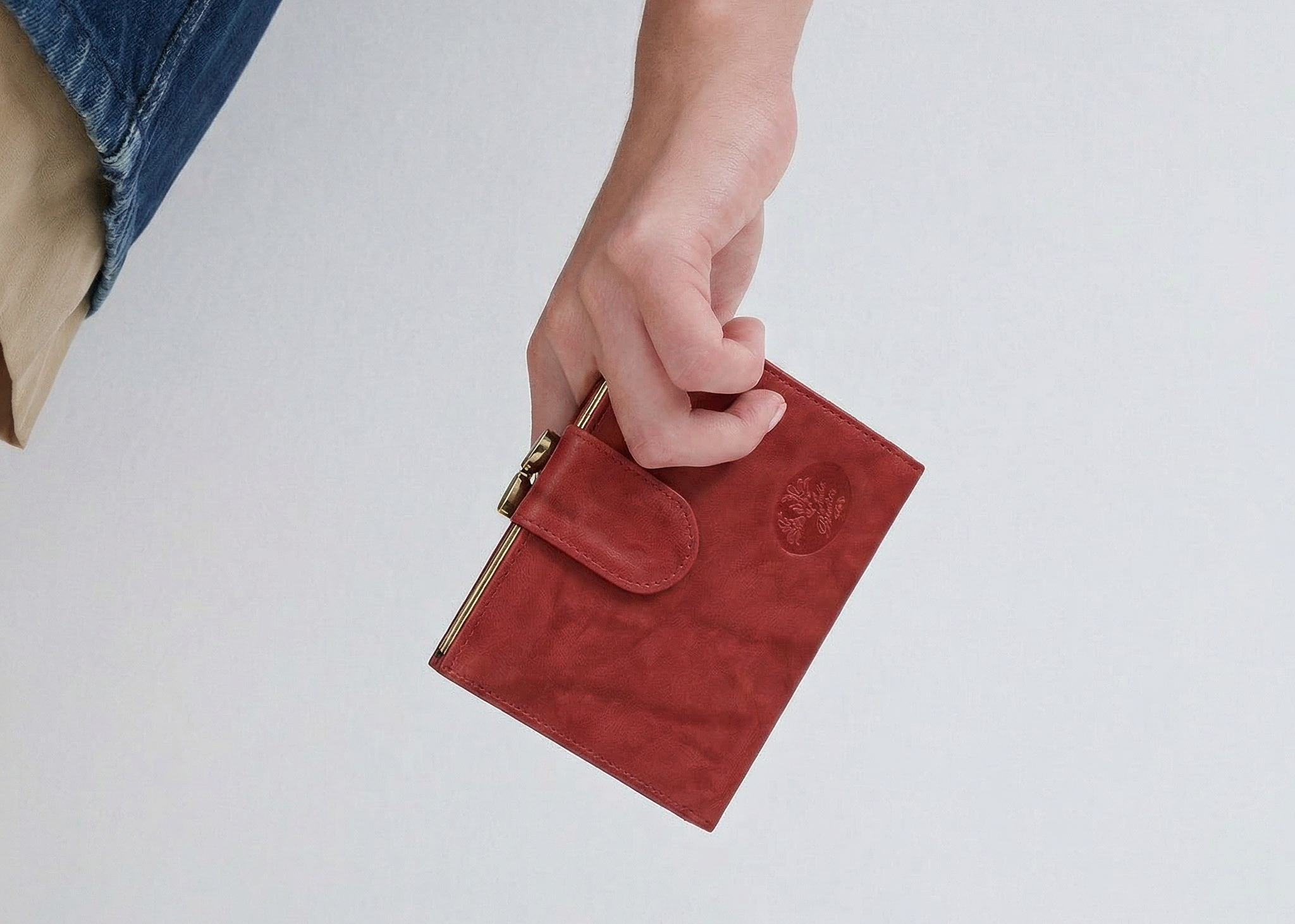 Hand holding Heiress Leather Double Cardex from Julia Buxton in red